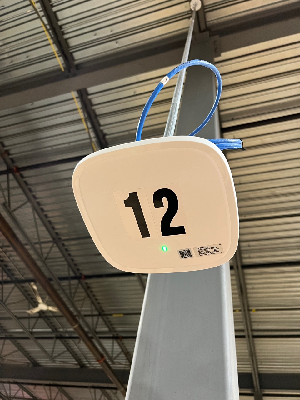 Wi-fi Access Point (AP) set up overhead at a warehouse.